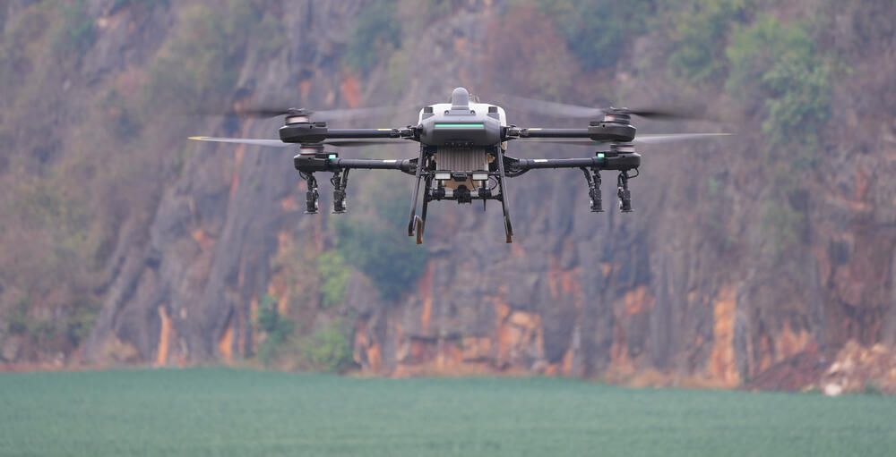 Q100P agricultural drone hovering in flight, seen from the front